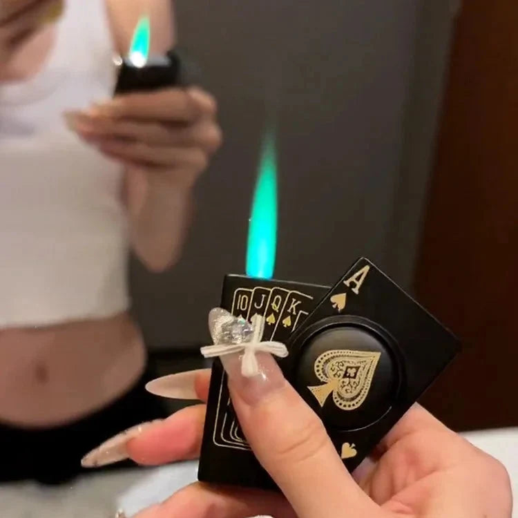 Hand holding Ace of Spades Poker Lighter with green windproof flame lit