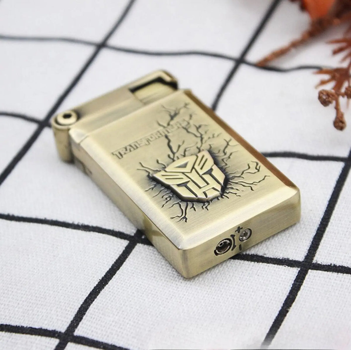 Bottom view of the Autobot lighter with butane refill valve visible