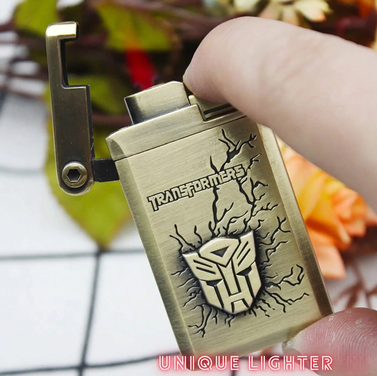 Hand holding Transformers Autobot Lighter with red jet flame lit